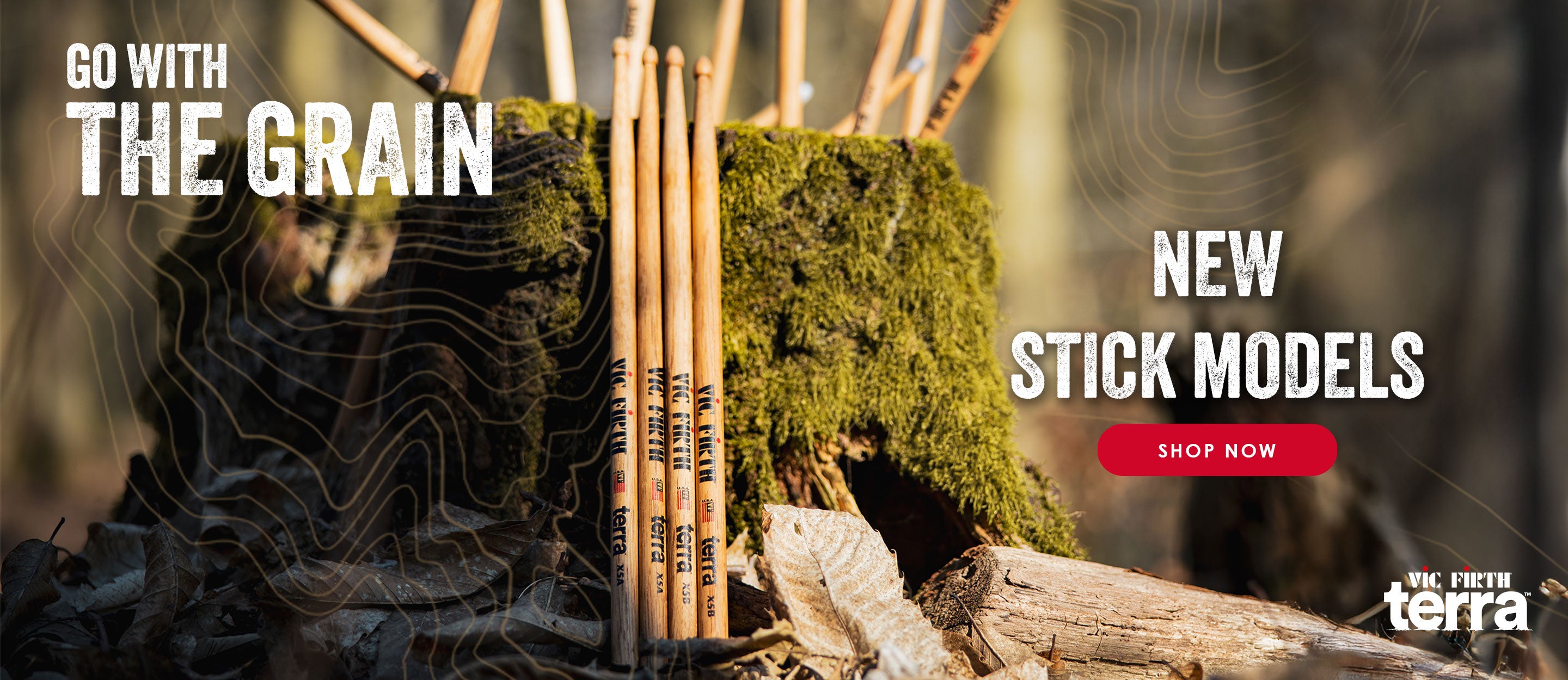 Close-up of X5A and X5B Terra drumsticks sticking out of a tree stump. Text reads: 'Go with the Grain' and 'New Stick Models