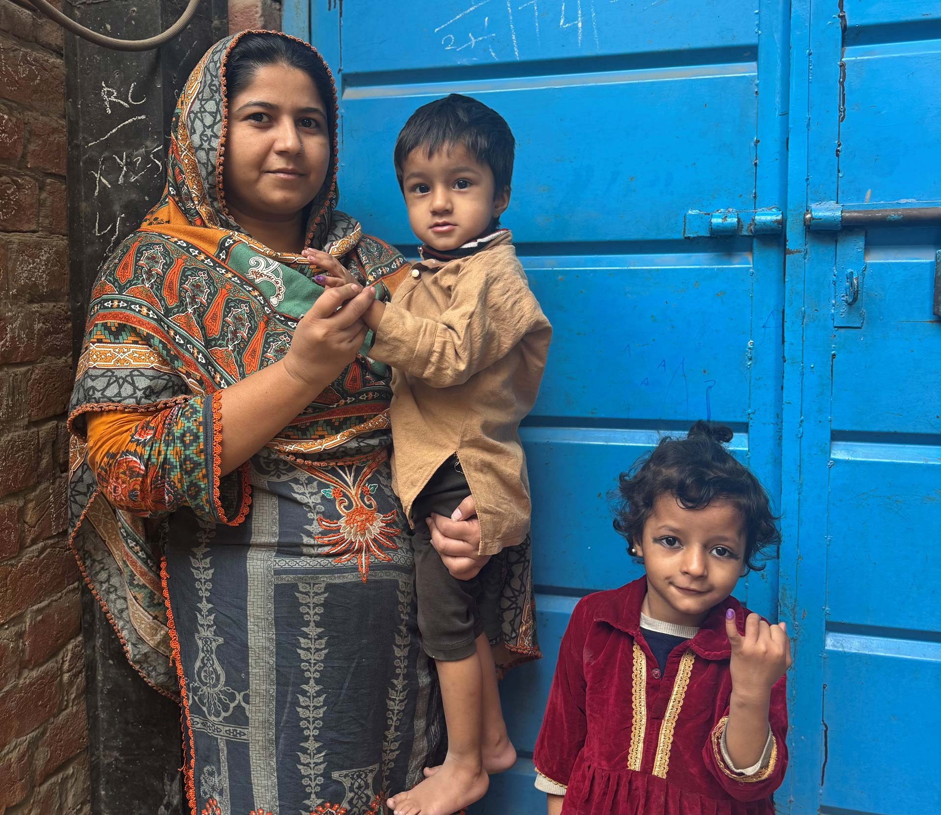 Aminah with her two children during the national measles-rubella vaccination campaign in Lahore, Pakistan, in November 2025. Photo credit: Ayesha Javed.