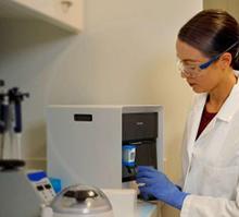 Worker using laboratory equipment.