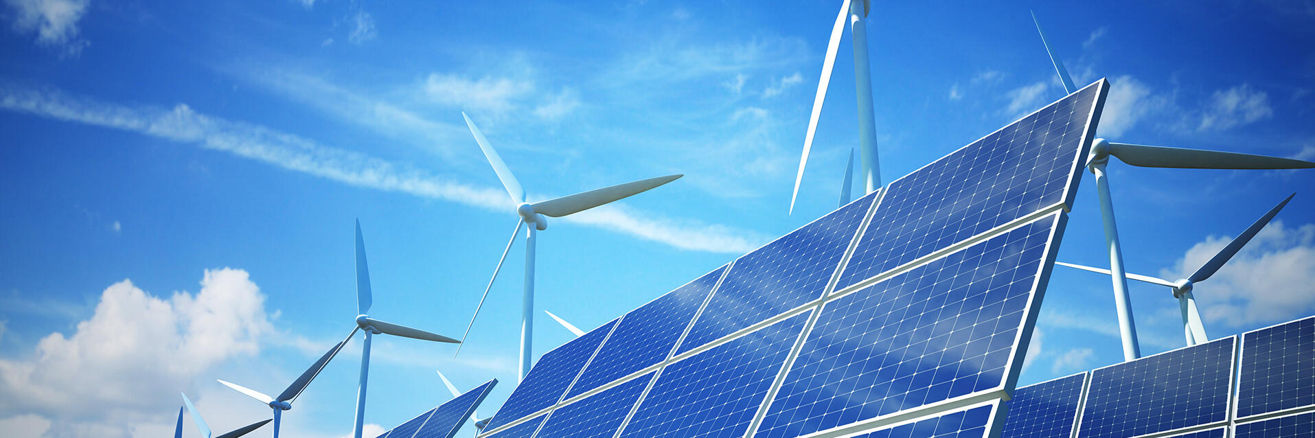 A photo of solar panels and wind turbines