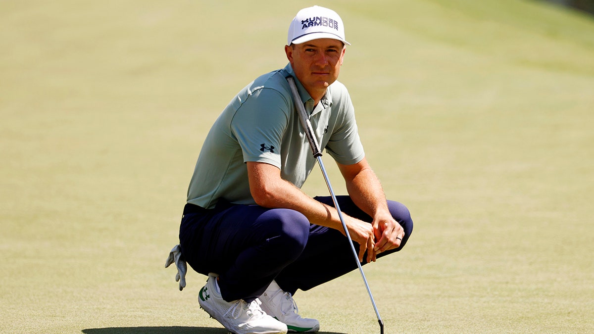 Jordan Spieth looks on