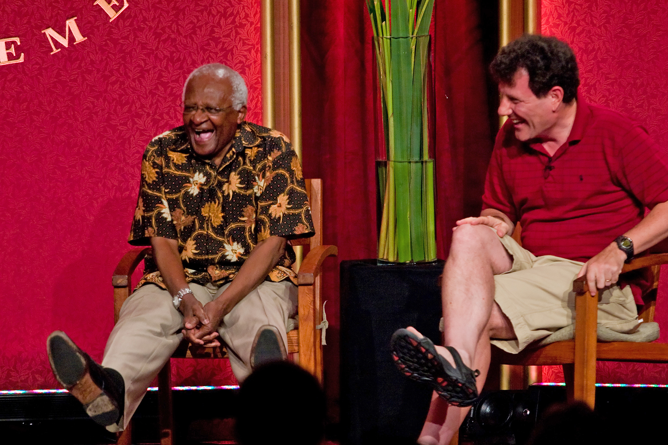Archbishop Desmond Tutu enjoys a light moment with journalist Nicholas Kristof during their panel discussion.