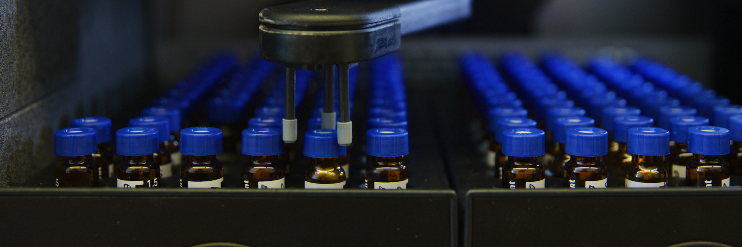Lab samples with blue lids being moved around with a machine