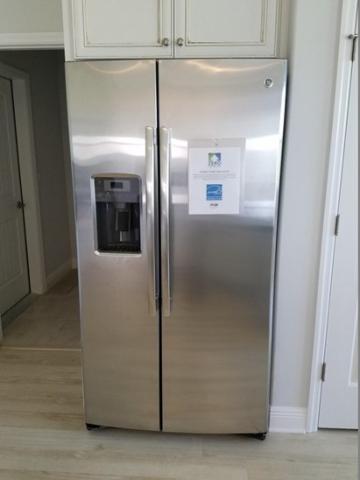 The cabinet above this refrigerator will keep it from tipping forward during a seismic event