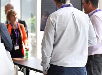 A man and woman standing in front of a table.