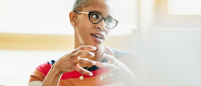 A women explaining and one laptop is open.