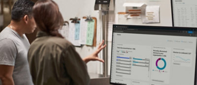 Two person are looking at screen