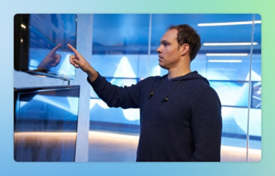 A person pointing at a screen.