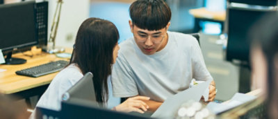 A man and a women working on laptop.