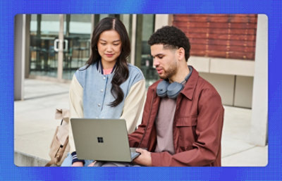 Ein Mann und eine Frau schauen auf einen Computer 