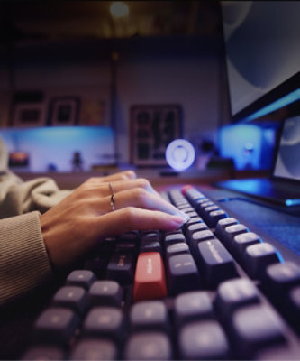 A hand typing on a keyboard.