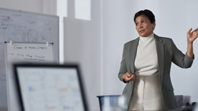 A women explaining and one laptop is open.