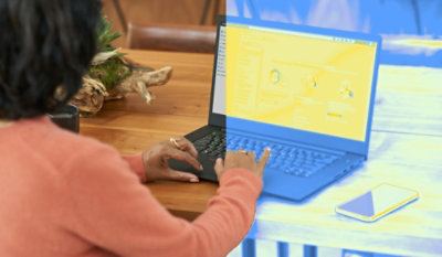 A woman looking on a laptop.