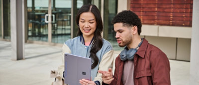 Een man en een vrouw die naar een tablet kijken.