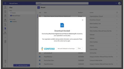 Snímek obrazovky počítače se zprávou „Download blocked“ a logem CONTOSO