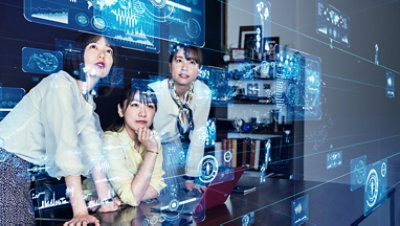 A digital projection shown in the air while three women watch it