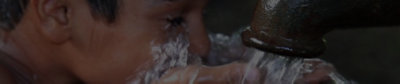 A child drinking clean water from a well