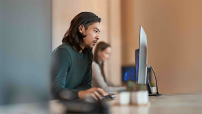 Enterprise office worker in focused work at computer