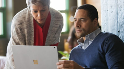 Man and women looking at a laptop