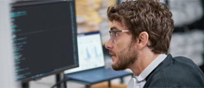 Person working on a computer with code on the screen.