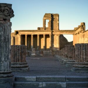 The sun rises over colonnade ruins at Pompeii