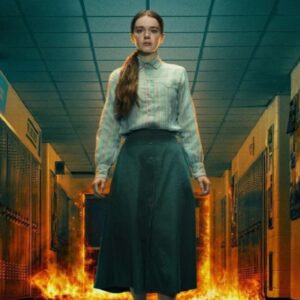 young girl in simple skirt and blouse standing in high school hallway as flames billow behind her