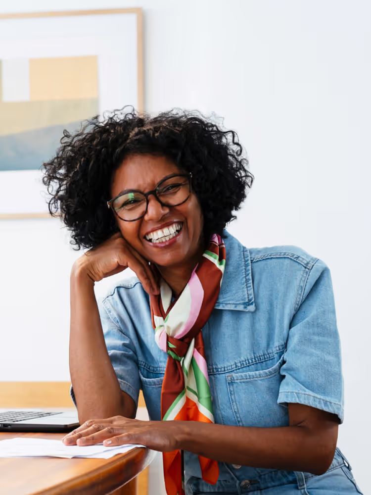 Woman smiling at desk hero m