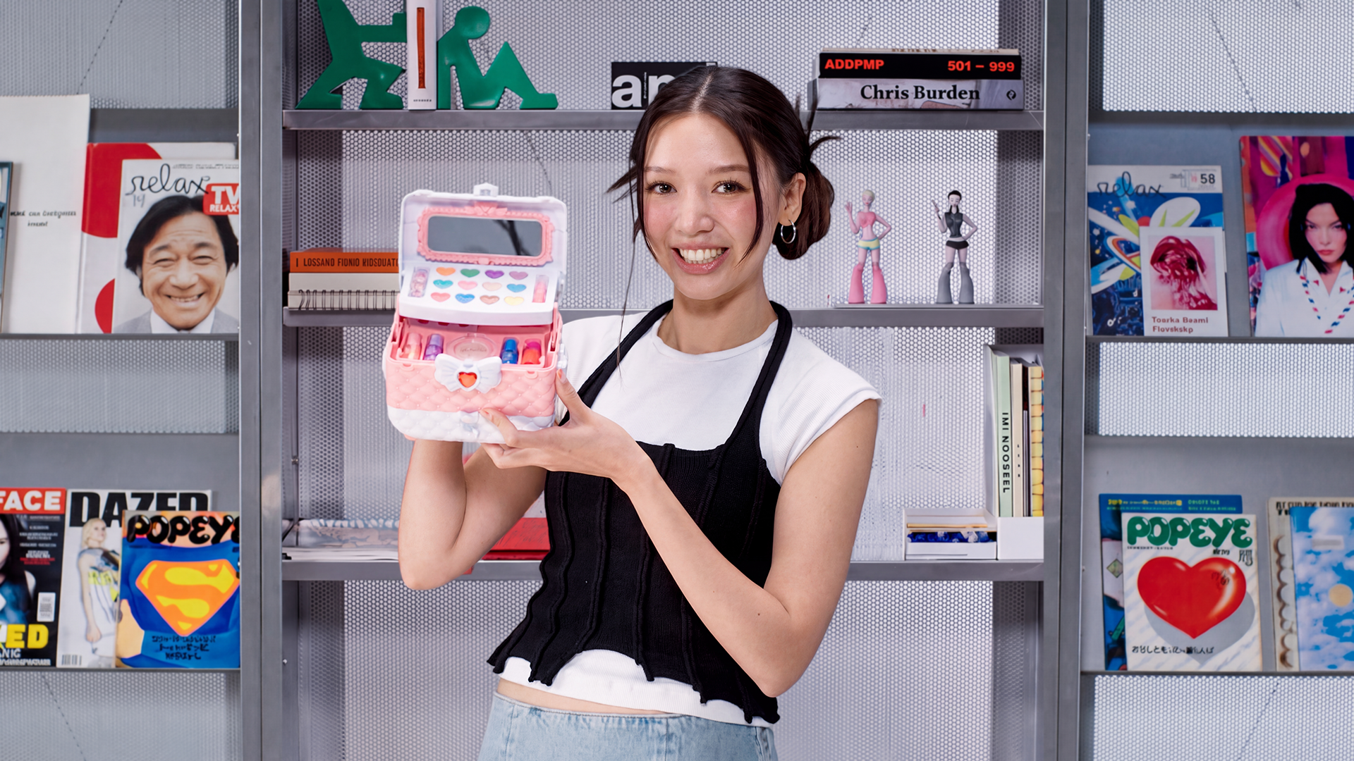 Marisa Chenkatul holds up a plastic pink makeup vanity