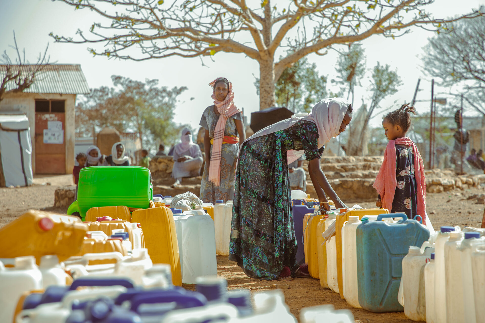 Women line up to get water