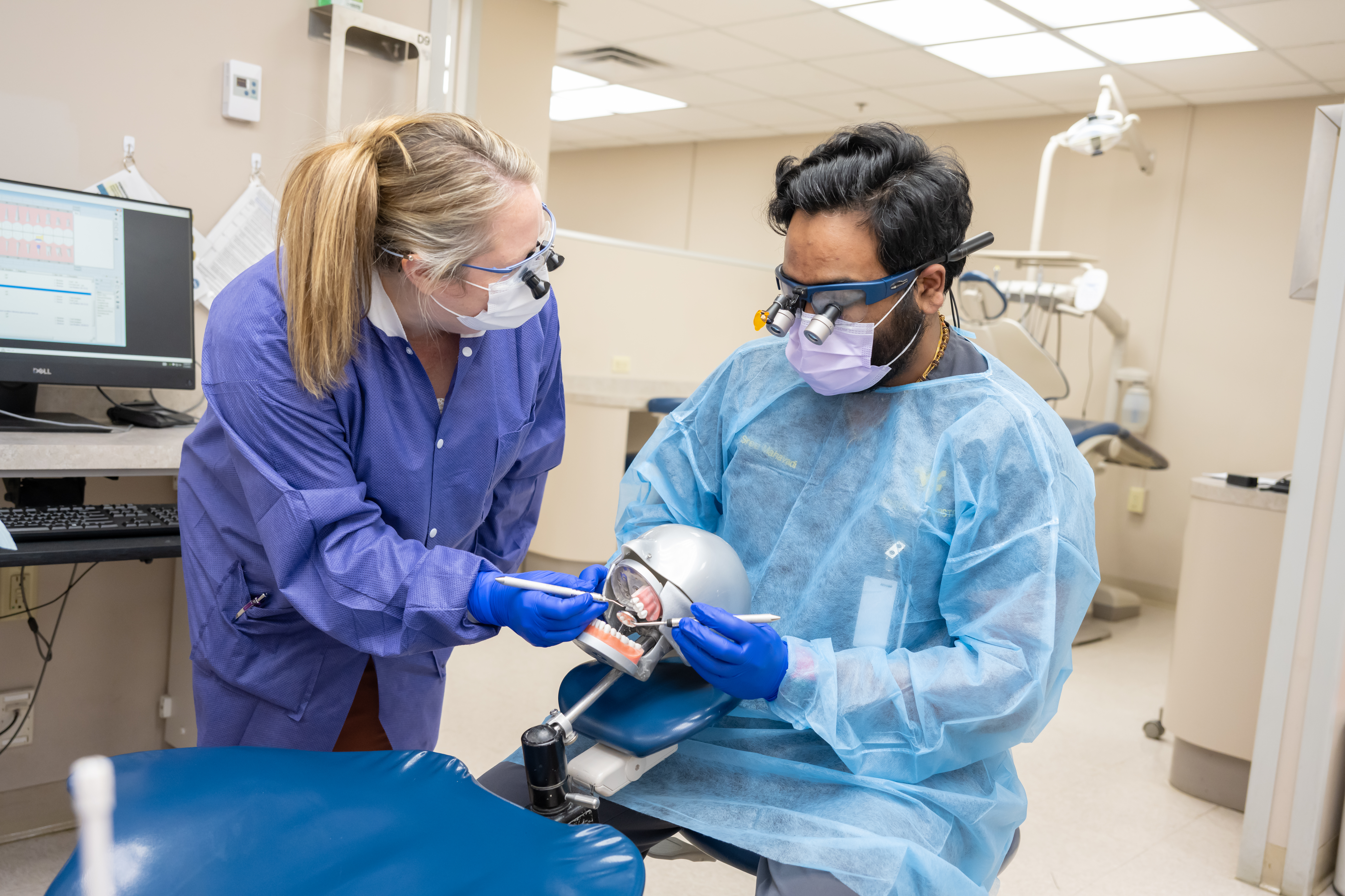 A dental student works in the simulation lab.