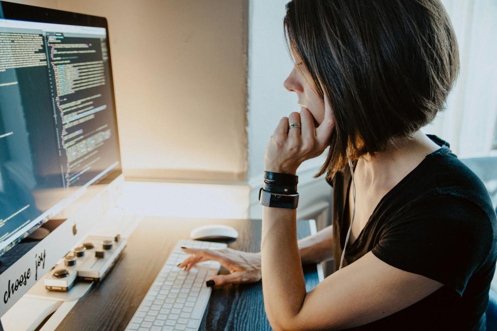 A lady looking at a computer screen