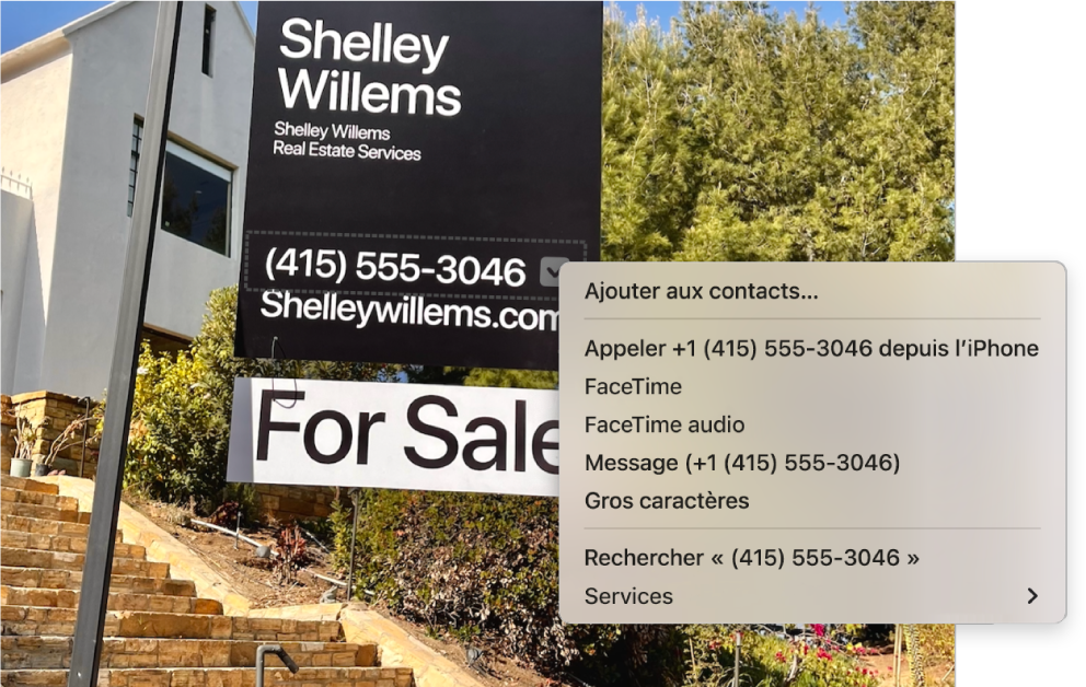 Photo d’une pancarte « For Sale » (À vendre) affichant le numéro de téléphone de l’agent sélectionné avec Texte en direct, ainsi qu’un menu avec des options pour ajouter le numéro de téléphone à Contacts, appeler le numéro, lancer un appel FaceTime, envoyer un message texte et bien plus encore.