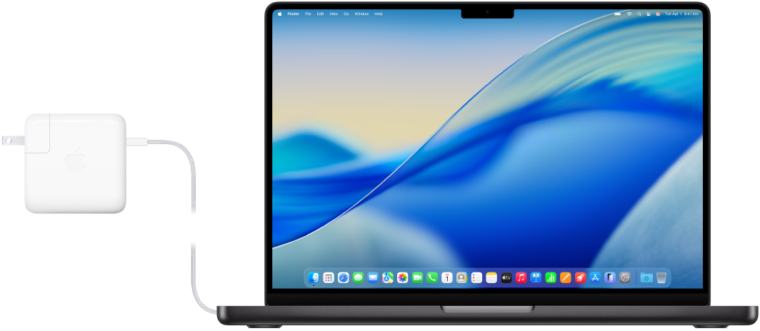 MacBook Pro 14 inci dengan adaptor daya yang terhubung.