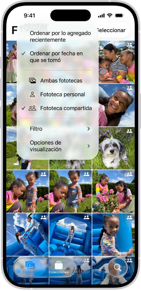 Una fototeca compartida en iCloud en la app Fotos. El botón Fototeca compartida de la esquina inferior izquierda está seleccionado y, en una lista de opciones de la fototeca, la fototeca compartida está seleccionada. Todas las fotos mostradas en la fototeca tienen un indicador de fototeca compartida en la esquina superior derecha.
