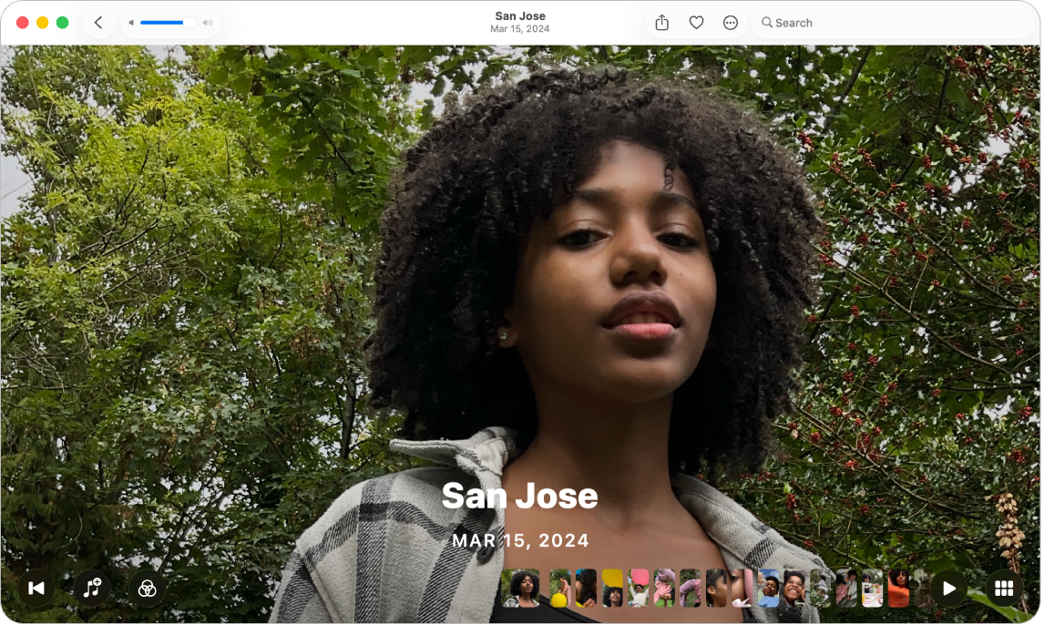 The Photos window showing a memory ready to play. A Rewind button, a Music button, a Filters button, a filmstrip with thumbnails of photos in the memory, a Play button and a Grid View button appear at the bottom.