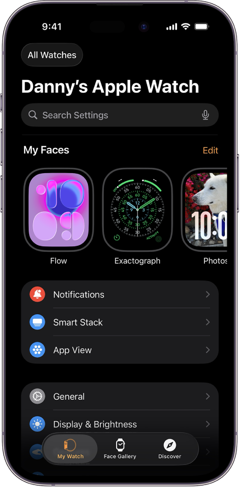 De Apple Watch-app op de iPhone, waarin het scherm 'Mijn Watch' is geopend, met bovenin de wijzerplaten en onderin de instellingen. Onder in het scherm van de Apple Watch-app staan drie tabbladen: links 'Mijn Watch', waar je de Apple Watch kunt instellen; daarnaast 'Wijzerplaten', waarmee je de beschikbare wijzerplaten en complicaties kunt bekijken; en daarnaast 'Ontdek', waar je meer informatie over je Apple Watch vindt.