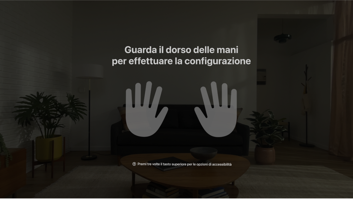 Configurazione delle mani su Apple Vision Pro, con istruzioni per l’utente di guardare le proprie mani di fronte a sé.