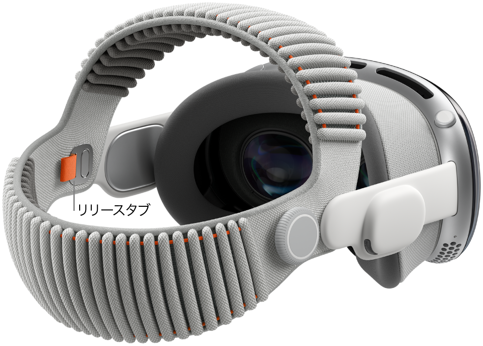デュアルニットバンドが取り付けられているApple Vision Pro。デュアルニットバンドの内側にオレンジのリリースタブがあります。