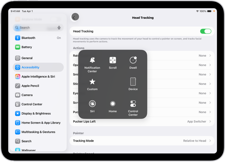 ஒரு iPadஇல் “தலை அசைவு” அம்சம் ஆன் செய்யப்பட்டுள்ளது. AssistiveTouch மெனு காட்டப்பட்டுள்ளது, இதில் அறிவிப்பு மையம், ஸ்க்ரால், டுவெல், சாதனம், கட்டுப்பாட்டு மையம், முகப்பு, Siri, பிரத்தியேகம் ஆகியவற்றுக்கான கட்டுப்பாடுகள் காட்டப்பட்டுள்ளன.