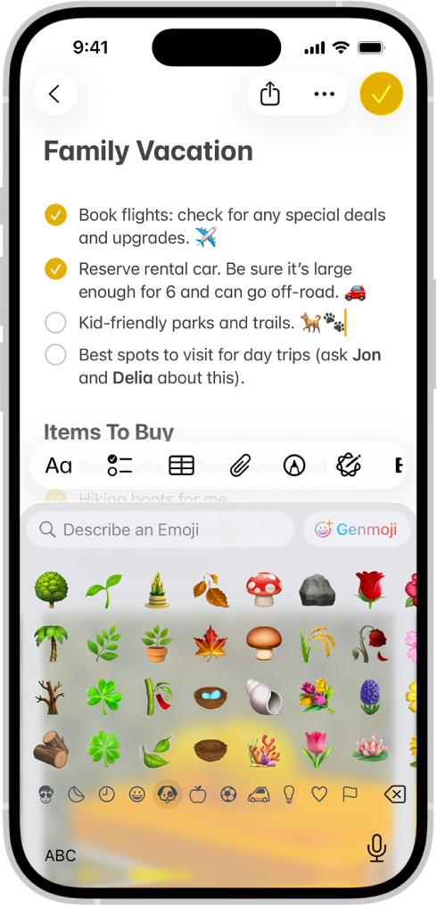 A note is open in the Notes app in the top half of the screen, and the emoji keyboard is open in the bottom half of the screen.