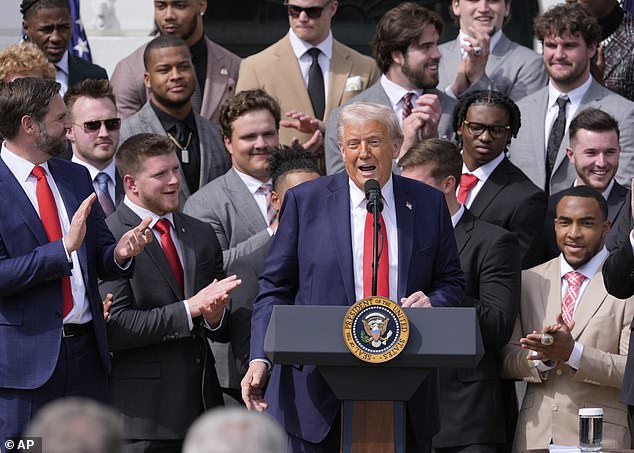 Trump speaks with Jeremiah Smith looking on over the President's left shoulder