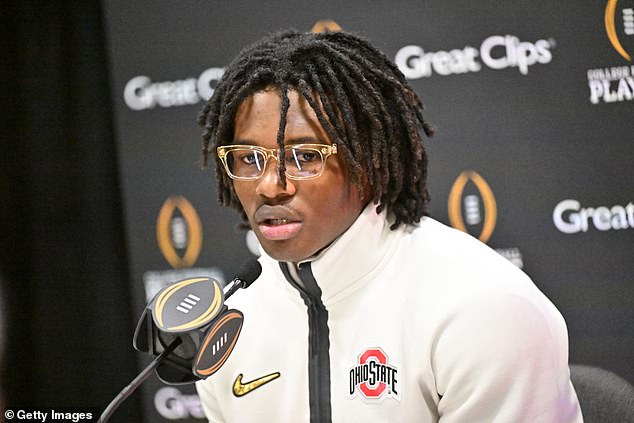 Jeremiah Smith #4 of the Ohio State Buckeyes speaks to the media during the Ohio State Buckeyes media day at the Georgia World Congress Center prior to the national title game