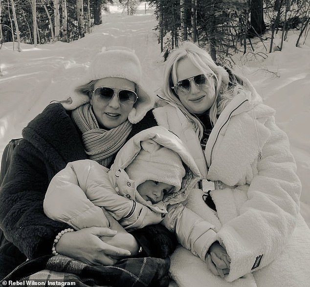 She also opens up about her daughter, who the pair welcomed by surrogacy in 2022, saying: 'Her name is Royce' (Pictured with her wife and daughter)
