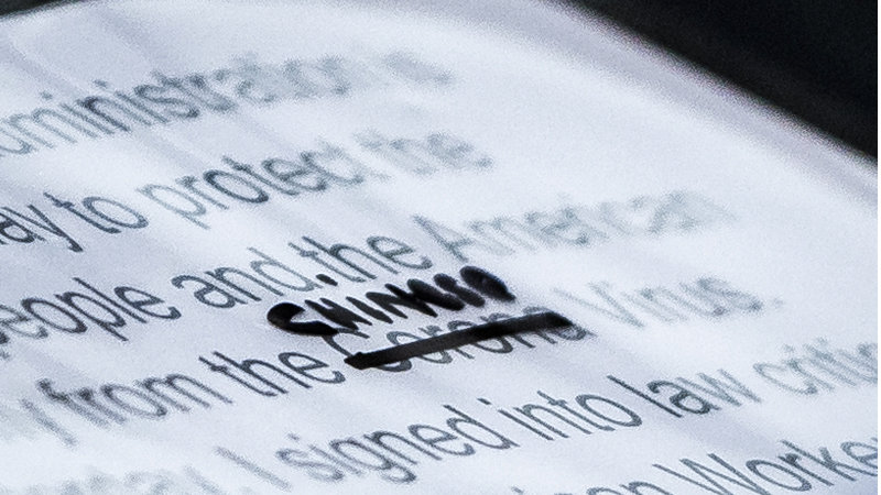 Chinese Virus Close-up photograph of president donald trump's speech about the coronavirus with the word "corona" crossed out and the word "chinese" written above it.