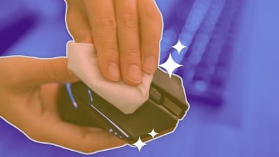 a blue background with a keyboard and in the foreground two hands cleaning a computer mouse