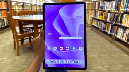 Lenovo Idea Tab Plus being held with left hand at library