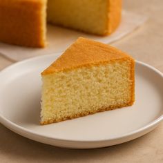 a slice of yellow cake on a white plate