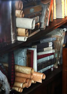 a shelf filled with lots of books and papers