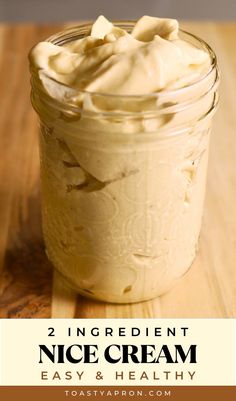 a jar filled with whipped cream on top of a wooden table
