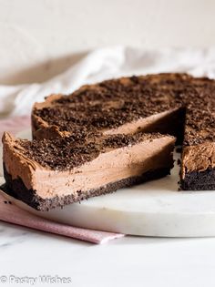a chocolate cake on a plate with one slice cut out